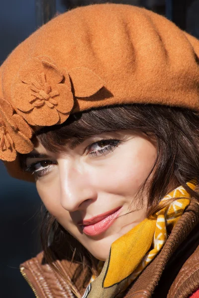 Portrait of beautiful brunette with the brown cap — Stock Photo, Image