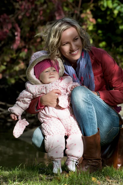 Young woman with little girl in autumn outdoors — Stock Photo, Image