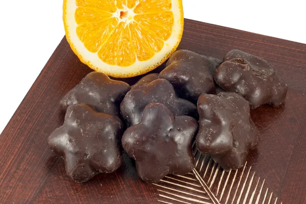 Gingerbread cakes and slice of orange on wooden table. — Stock Photo, Image