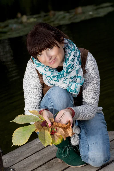 Young beautiful brunette with autumn decoration — Stock Photo, Image