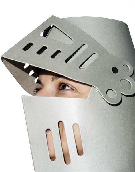 Woman with knight's helmet on the head