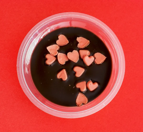 Tasty pudding with little hearts of marzipan — Stock Photo, Image