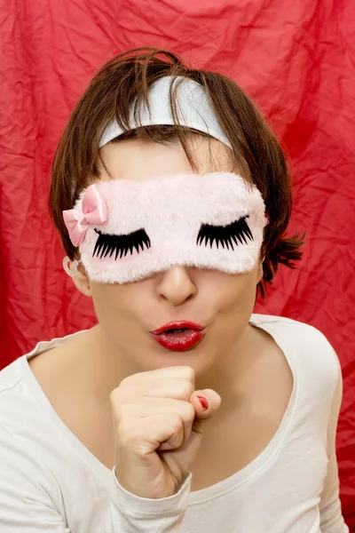 Young woman in sleeping mask imitates singing into a microphone — Stock Photo, Image