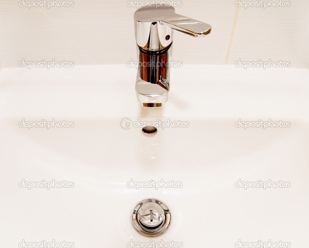White sink and chrome faucet with handle