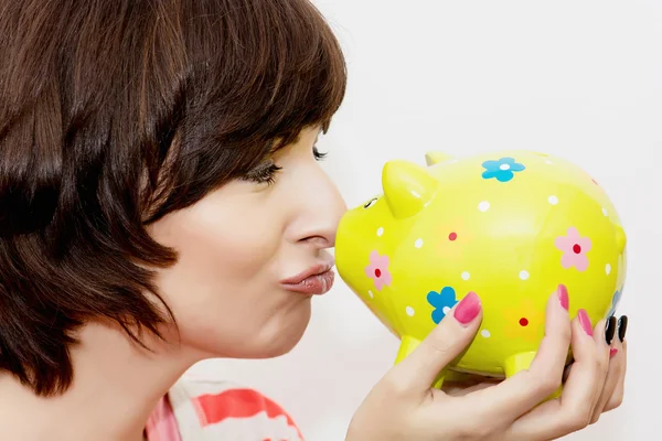 Young funny woman with decorative ceramic piggy bank — Stock Photo, Image