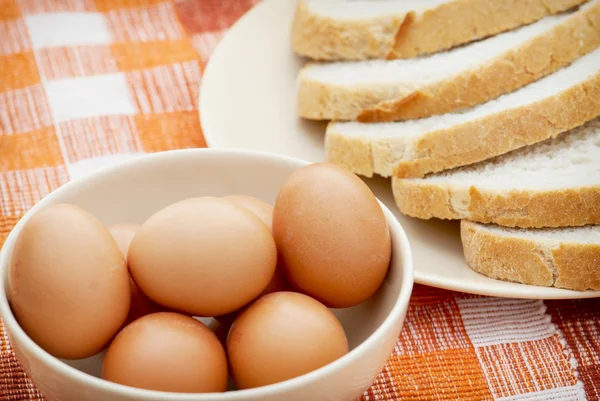 Rauwe eieren en tarwe brood gesneden — Stockfoto