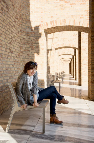 Pretty woman posing on a bench — Stock Photo, Image