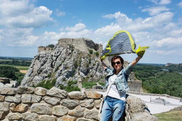 Beautiful woman with fluttering scarf on Devin castle