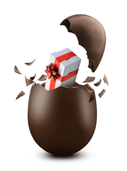 Broken chocolate easter egg with exploded eggshell and gift box inside, on white background
