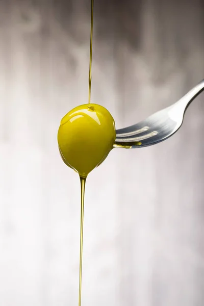 Green Olive Fork Dripping Oil Wooden Background — Stock Photo, Image