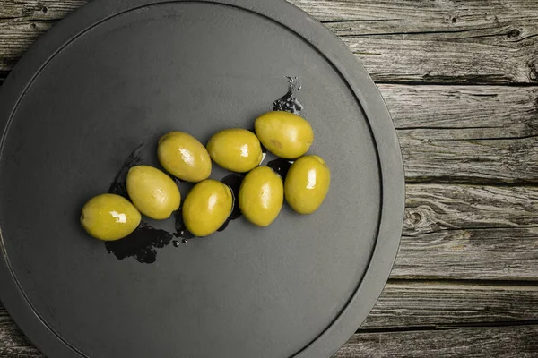Big Green Olives Black Plate Wooden Table — Stok fotoğraf