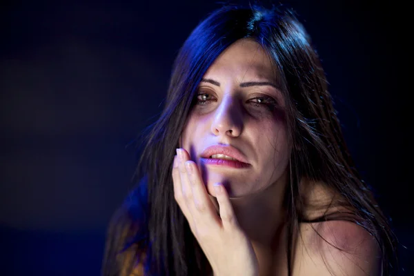 Beautiful woman hit touching brooses in face