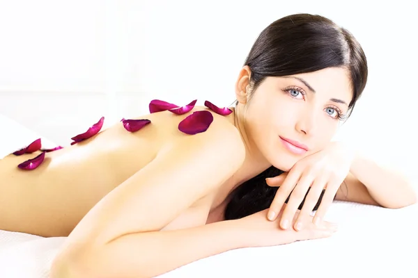 Angelic portrait of beauty with flower on naked back in white spa — Stock Photo, Image