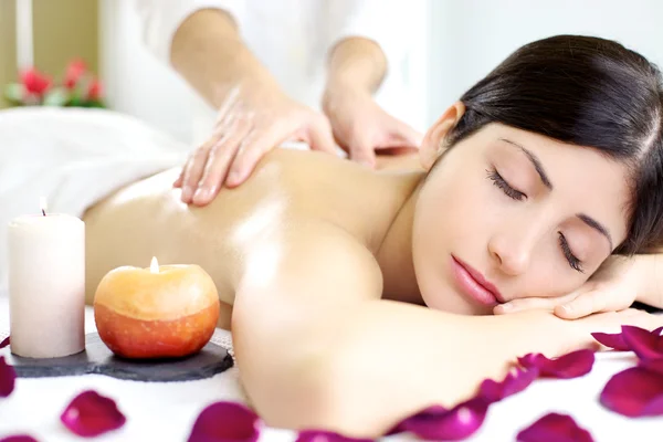 Happy relaxed woman getting back massage in luxury spa — Stockfoto