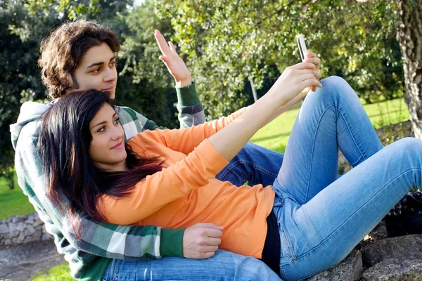 Happy couple photographing with mobile phone — Stock Photo, Image
