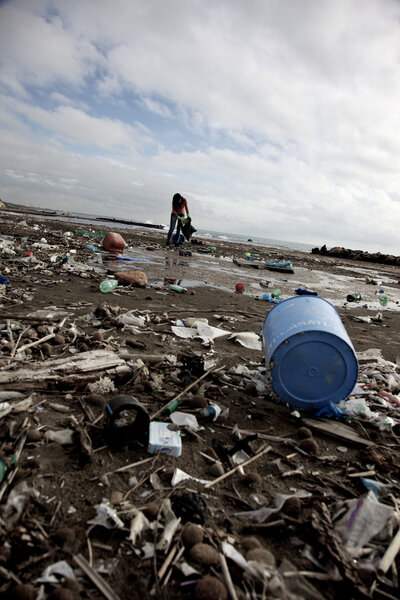 Young social worker in a impossible damaged beach
