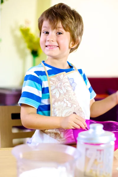 Happy smiling kid cooking at home — Stock Photo, Image