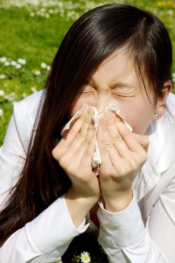 Portrait of sic chinese woman sneezing because of allergy and flu clipart