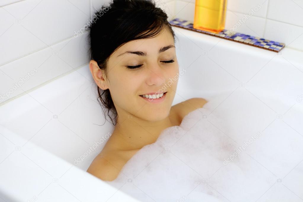 Young woman relaxing taking a bath