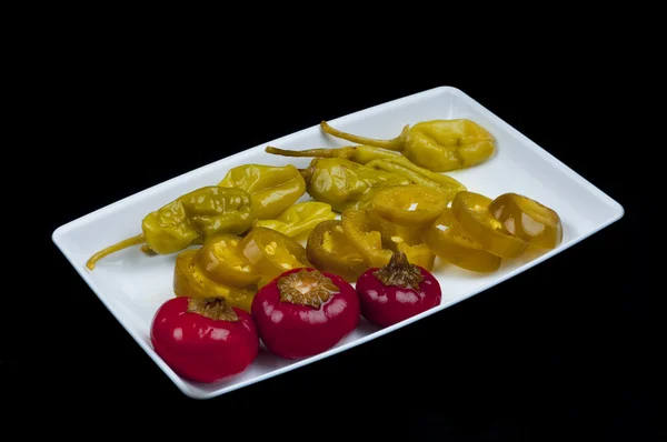 Mixed pepper pickles on the white plate — Stock Photo, Image