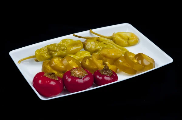 Mixed pepper pickles on the white plate — Stock Photo, Image