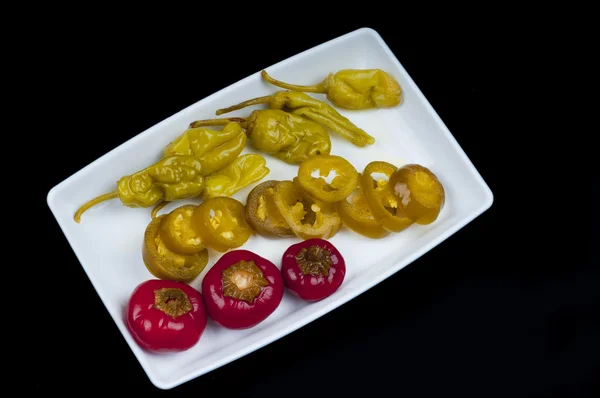 Mixed pepper pickles on the white plate at Top view — Stock Photo, Image