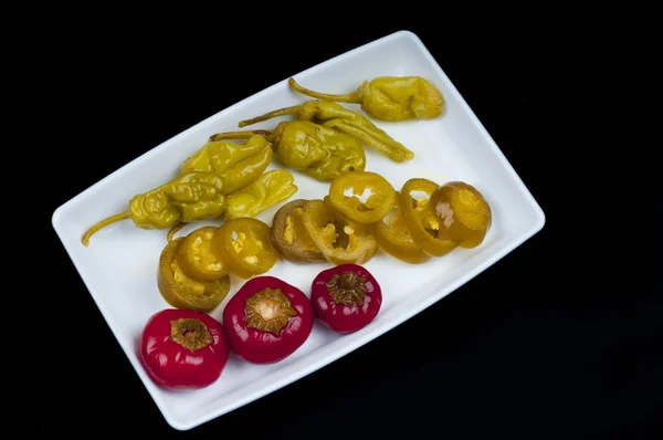 Mixed pepper pickles on the white plate at Top view Royalty Free Stock Photos