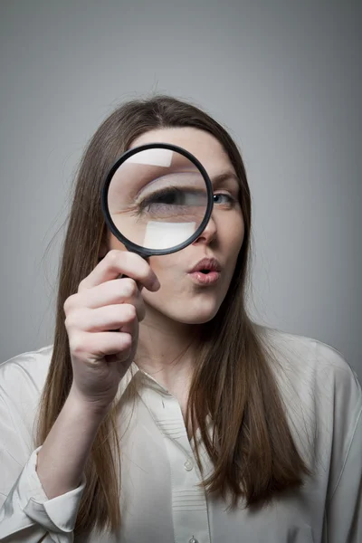 Woman with magnifier — Stock Photo, Image