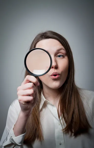 Woman with magnifier — Stock Photo, Image