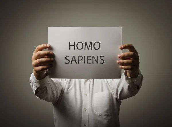 Man is holding a paper is his hands. Homo sapiens. — Stock Photo, Image