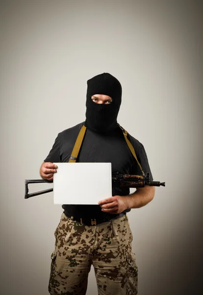 Gunman is holding white paper — Stock Photo, Image