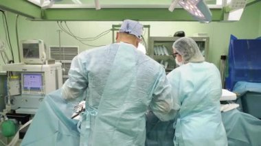 Profesyonel çok ırklı doktorlar hastane odasında ameliyat yapıyor.