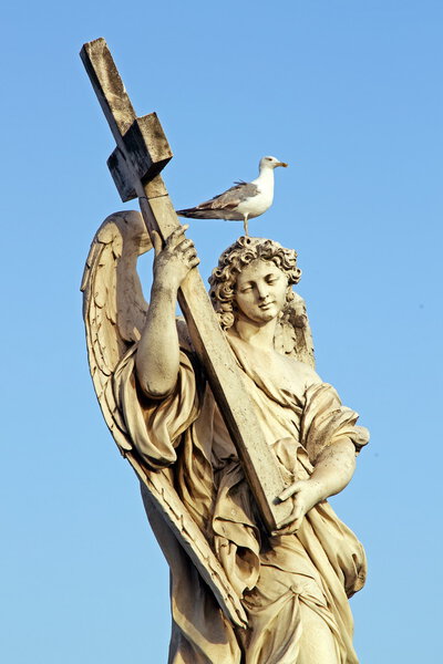 Marble statue of an Angel, in Rome, with cross and seagull