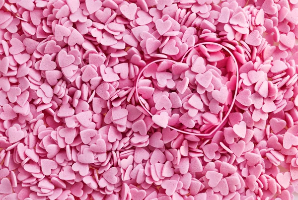 Rosa hjerte med godteri  . – stockfoto