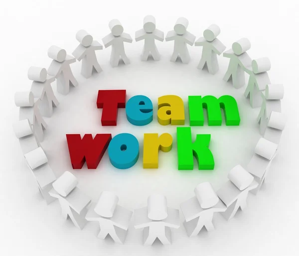 La gente se para alrededor de una palabra trabajo en equipo. La concepción de la cooperación está al mando . — Foto de Stock