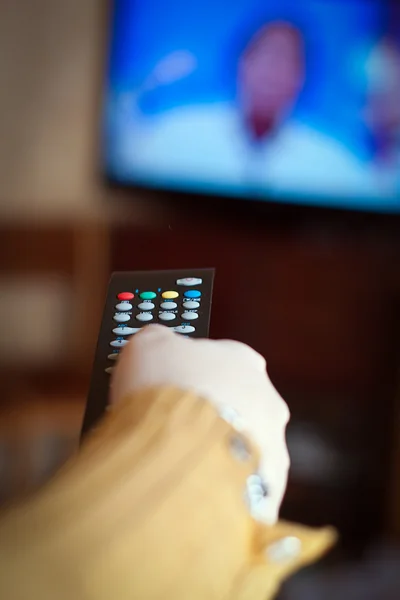 Hand holding TV remote control — Stock Photo, Image