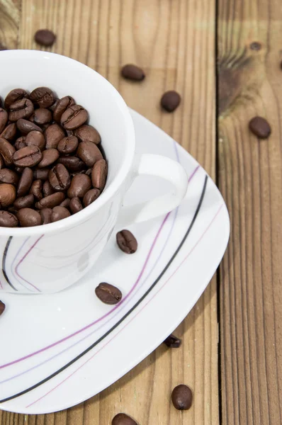 Coffee Beans in a Cup on wood — Stok Foto