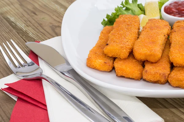 Portion of Fish Fingers on wooden background — Stock Photo, Image