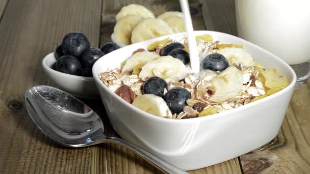 Pouring Milk into a bowl with Muesli — Stock Video