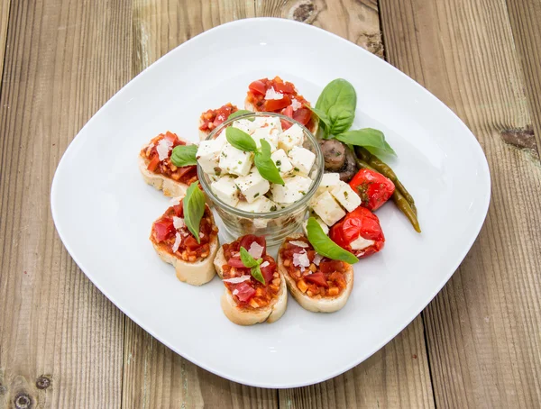 Plate with Feta Cheese and Bruschetta — Stock Photo, Image