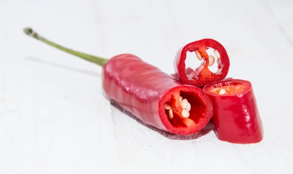 Chopped Pepperoni on white wood — Stock Photo, Image