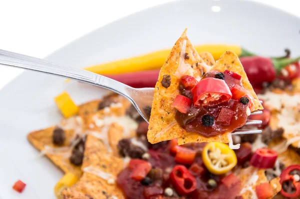 Nachos on a fork against white — Stock Photo, Image