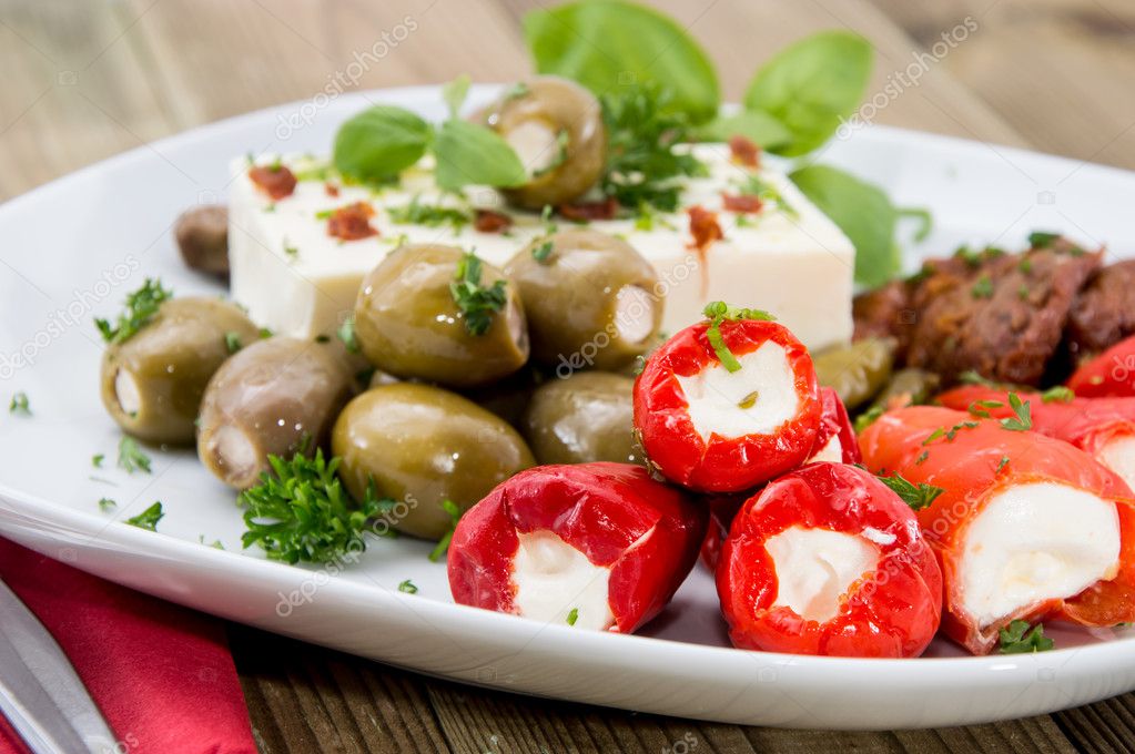 Different types of Antipasto on a plate Stock Photo by ©HandmadePicture