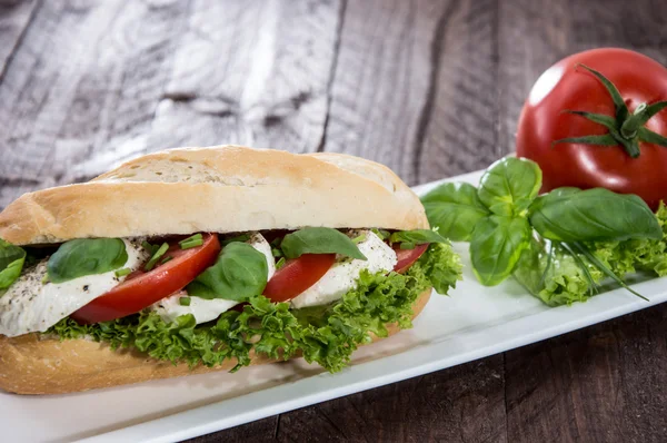 Hausgemachtes Mozzarella-Baguette auf einem Teller — Stockfoto