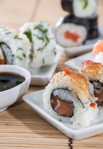 Rollos de sushi con palos y salsa de soja —  Fotos de Stock