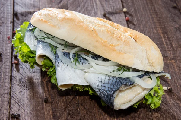 鲱鱼菲力一法棍面包 (靠木头上) — 图库照片