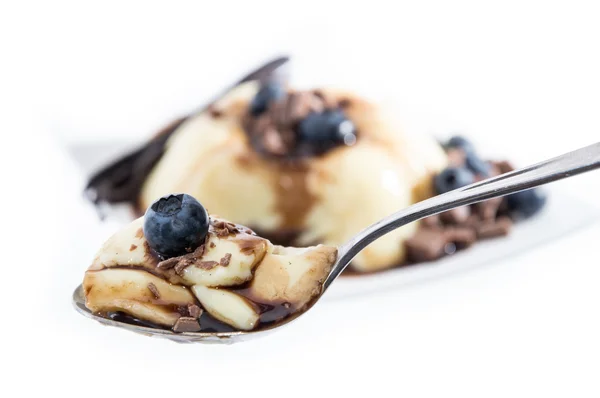 Vanilla Pudding on a spoon (white background) — Stock Photo, Image