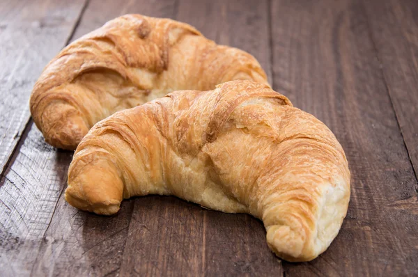 Croissants on wooden background — Stock Photo, Image