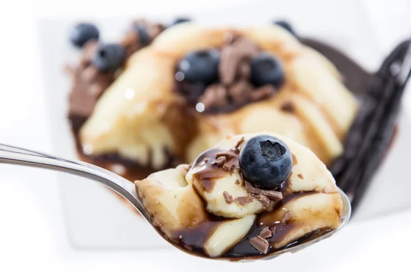 Vanilla Pudding on a spoon (white background) — Stock Photo, Image