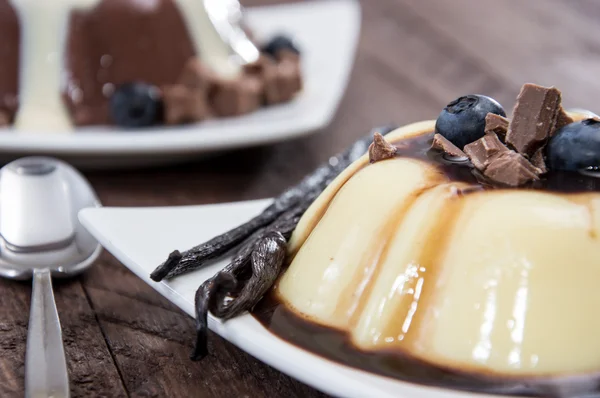 Different sorts of Pudding on wooden background — Stock Photo, Image